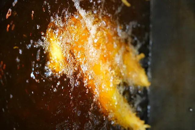 Hand-cut chips bubbling golden in the fryer at Ideal Fish & Chips in Bromsgrove