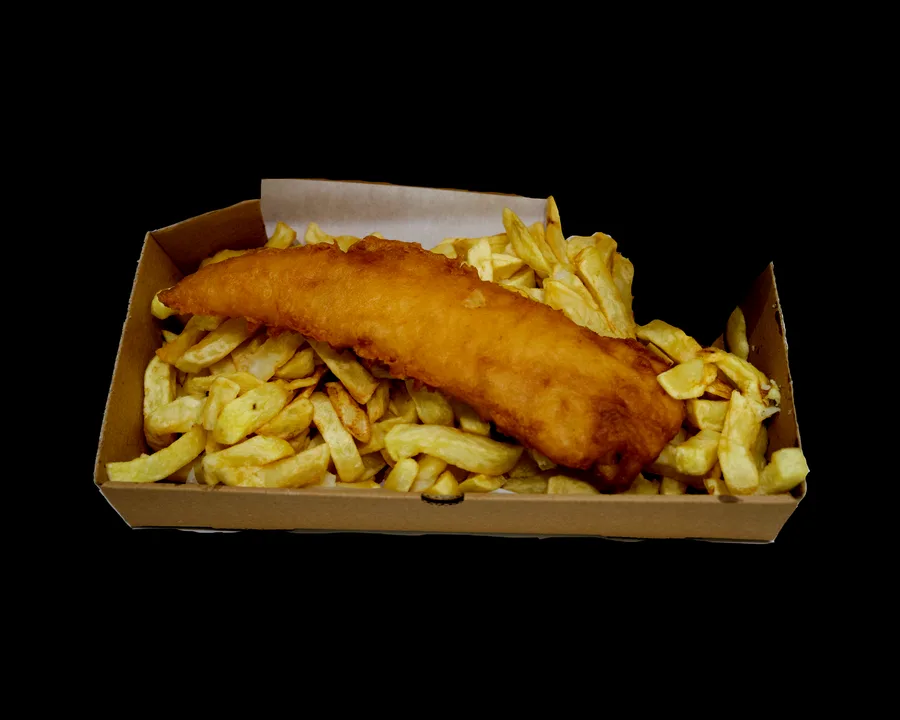 A whole fillet of cod in crisp golden batter, resting on a bed of thick-cut chips in an open takeaway box