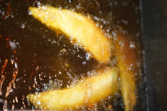 Thick-cut chips frying golden in bubbling Frymax vegetable oil